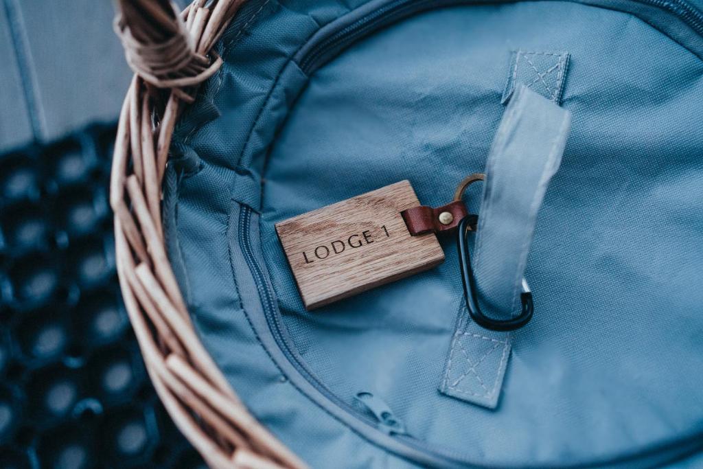 a wooden tag on a blue backpack at RiverBeds - Luxury Wee Lodges with Hot Tubs in Glencoe