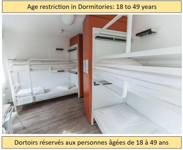 a room with two bunk beds in it at City Hostel Geneva in Geneva