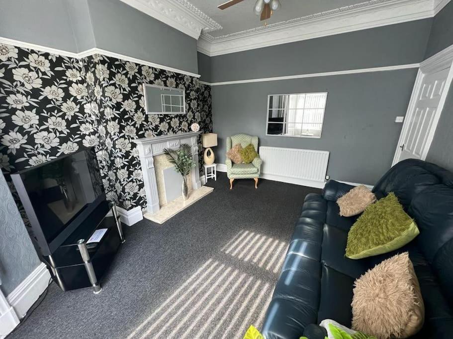 a living room with a couch and a television at No 33 Central Blackpool in Blackpool