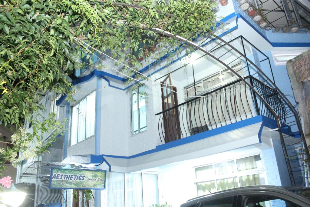 a blue and white building with a balcony at AESTHETICS - THE HOME STAY in Shillong