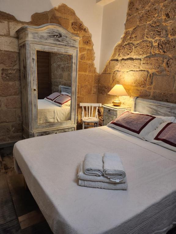 a bedroom with a large bed with towels on it at Aliga in Alghero