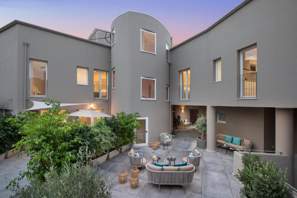 an exterior view of a building with a patio at MEM Lodge and Suite in Pula