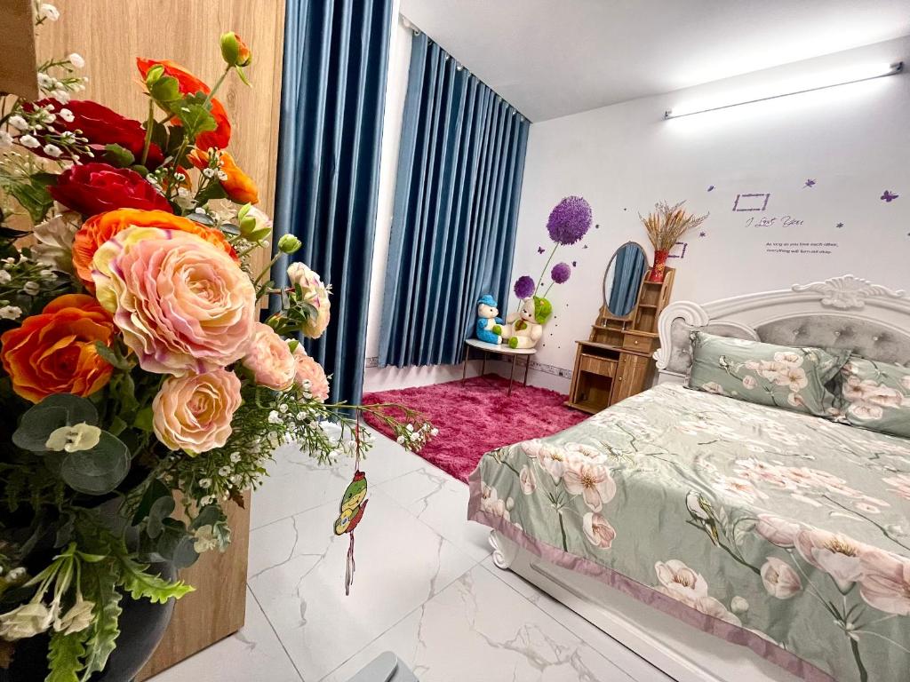 a bedroom with a bed and flowers on the wall at Thảo Nguyên Hotel in Vung Tau
