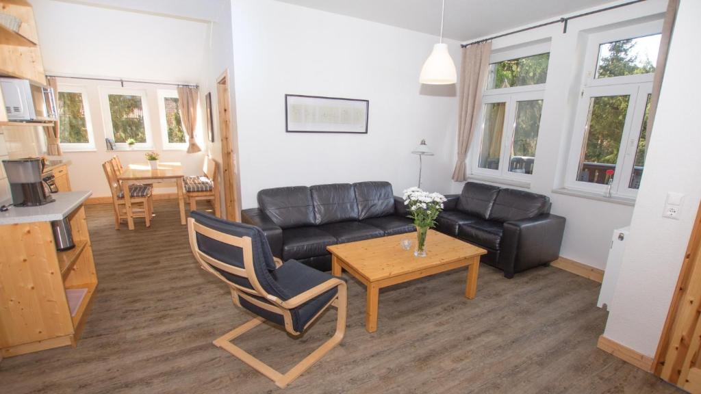 a living room with a couch and a table at Ferienwohnung Forsthaus am Brocken, 60 qm, 3 Schlafzimmer F5 in Ilsenburg