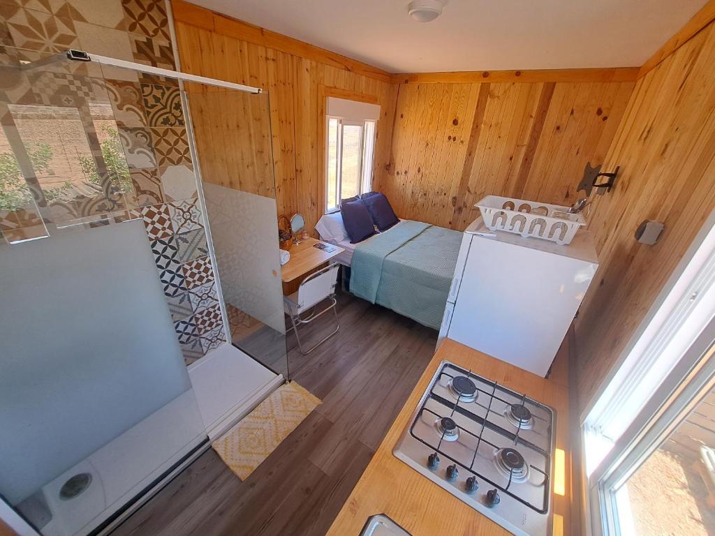 an overhead view of a room with a bed and a kitchen at Tiny house camión fijo en Islas Canarias in Triquivijate