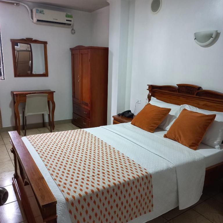 Postel nebo postele na pokoji v ubytování Hostal Bicentenario