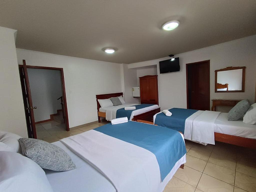 Postel nebo postele na pokoji v ubytování Hostal Bicentenario