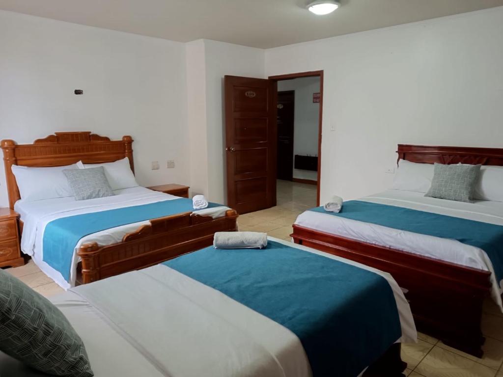 Postel nebo postele na pokoji v ubytování Hostal Bicentenario