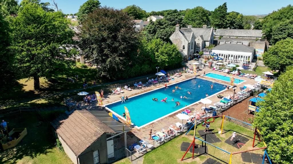 an overhead view of a swimming pool with people in it at Atlantic Reach Resort in Newquay