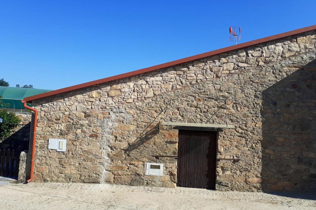 a large brick building with a door on it at One bedroom house with enclosed garden and wifi at Parada in Parada