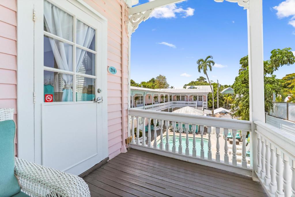 a balcony with a door and a view of the pool at The Palms Hotel in Key West