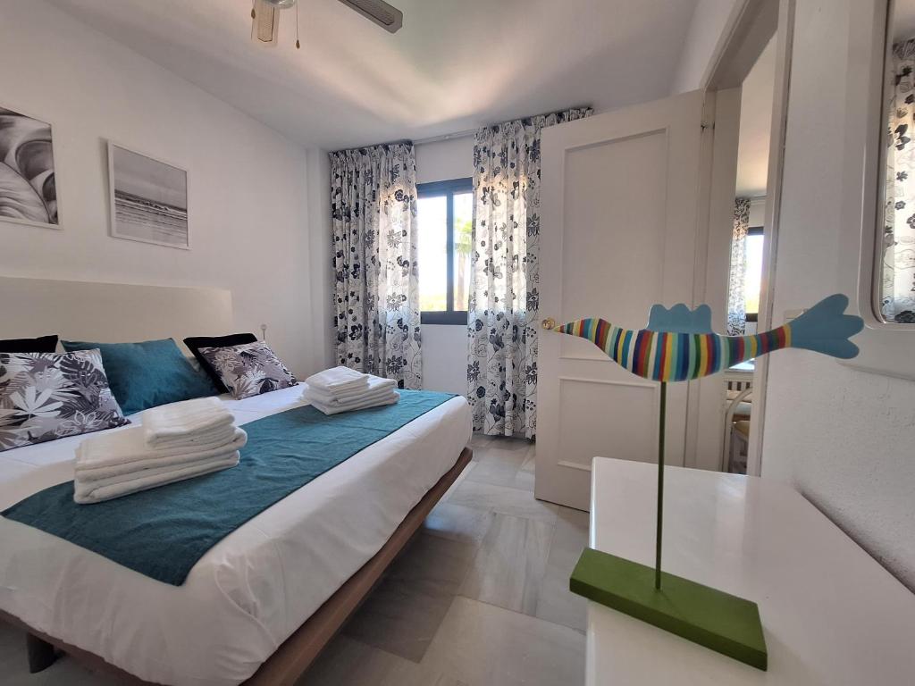 a bedroom with a large bed and a window at Primera Linea del Mar - Acceso Directo Playa Carihuela in Torremolinos