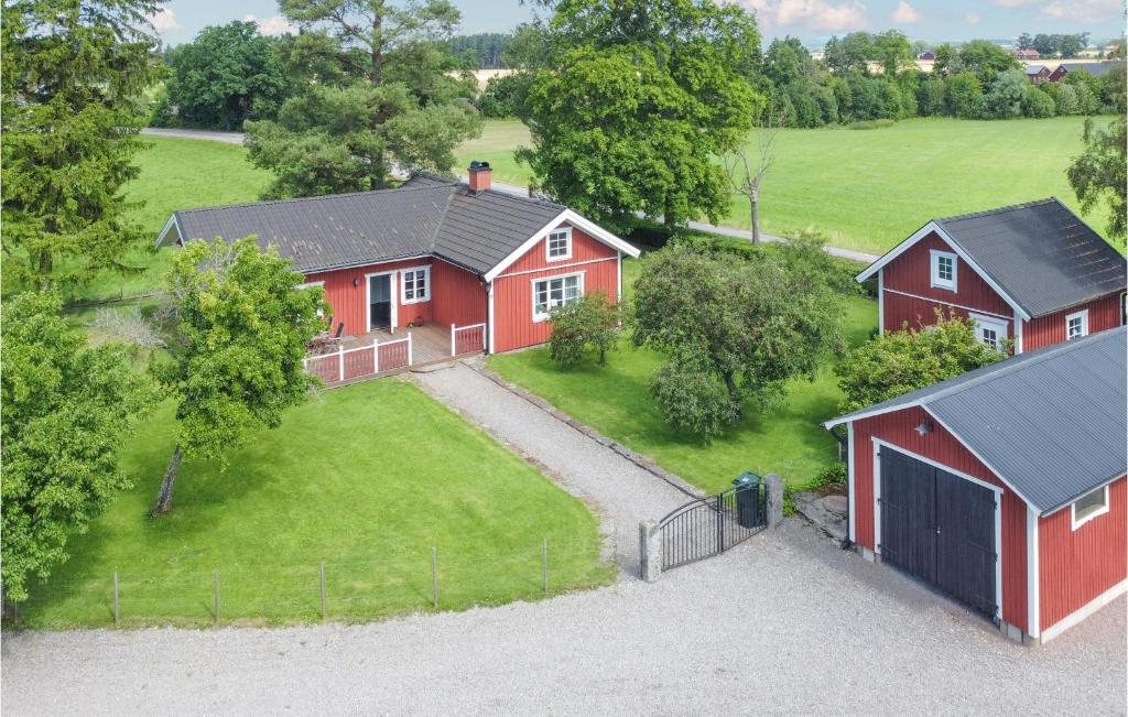 an aerial view of a red house with a barn at Lovely Home In Kllby With Wifi in Källby