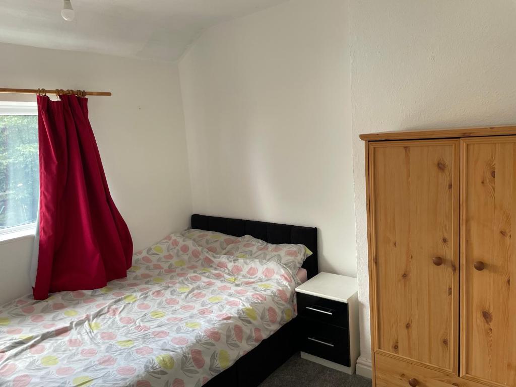 a bedroom with a bed and a dresser next to a window at 3 Mayfield rd in Tipton