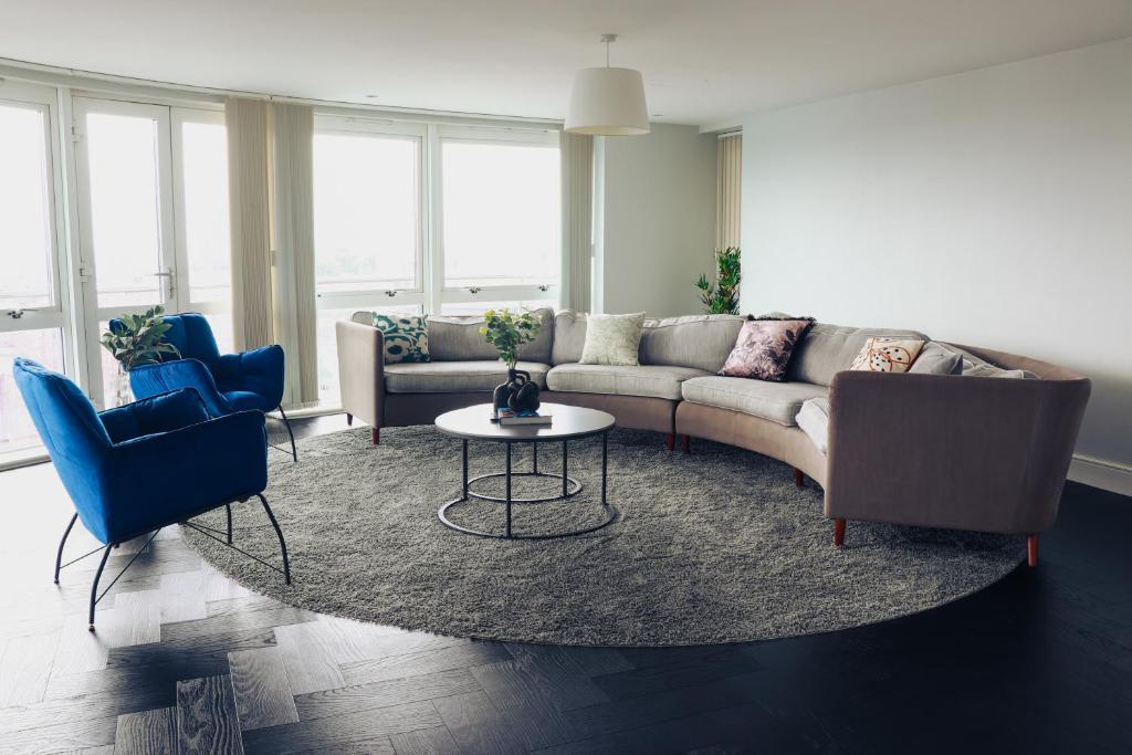 a living room with a couch and two chairs and a table at Luxury Three-Bedroom Penthouse- By Resify in Nottingham