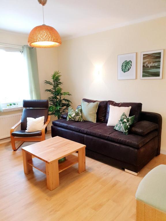 a living room with a couch and a coffee table at Ferienhaus Hahn in Bad Frankenhausen