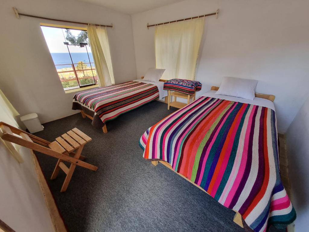 Postel nebo postele na pokoji v ubytování Inca lodge - Amantani
