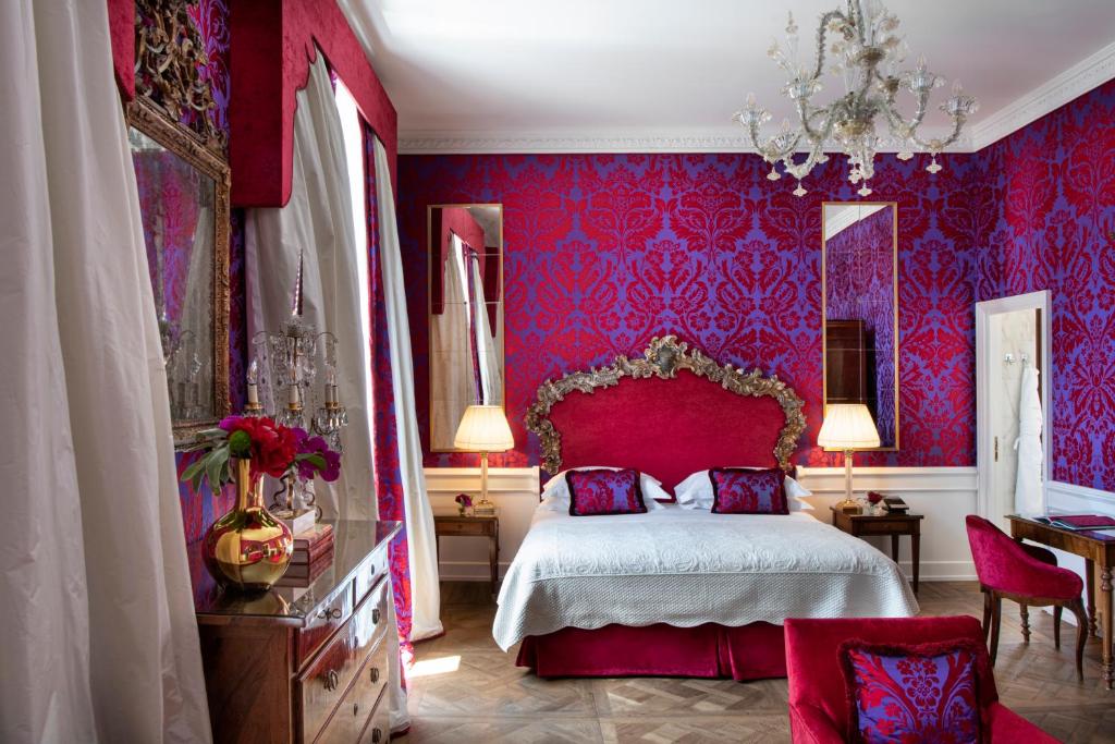 a red bedroom with a bed and red walls at Helvetia&Bristol Firenze – Starhotels Collezione in Florence