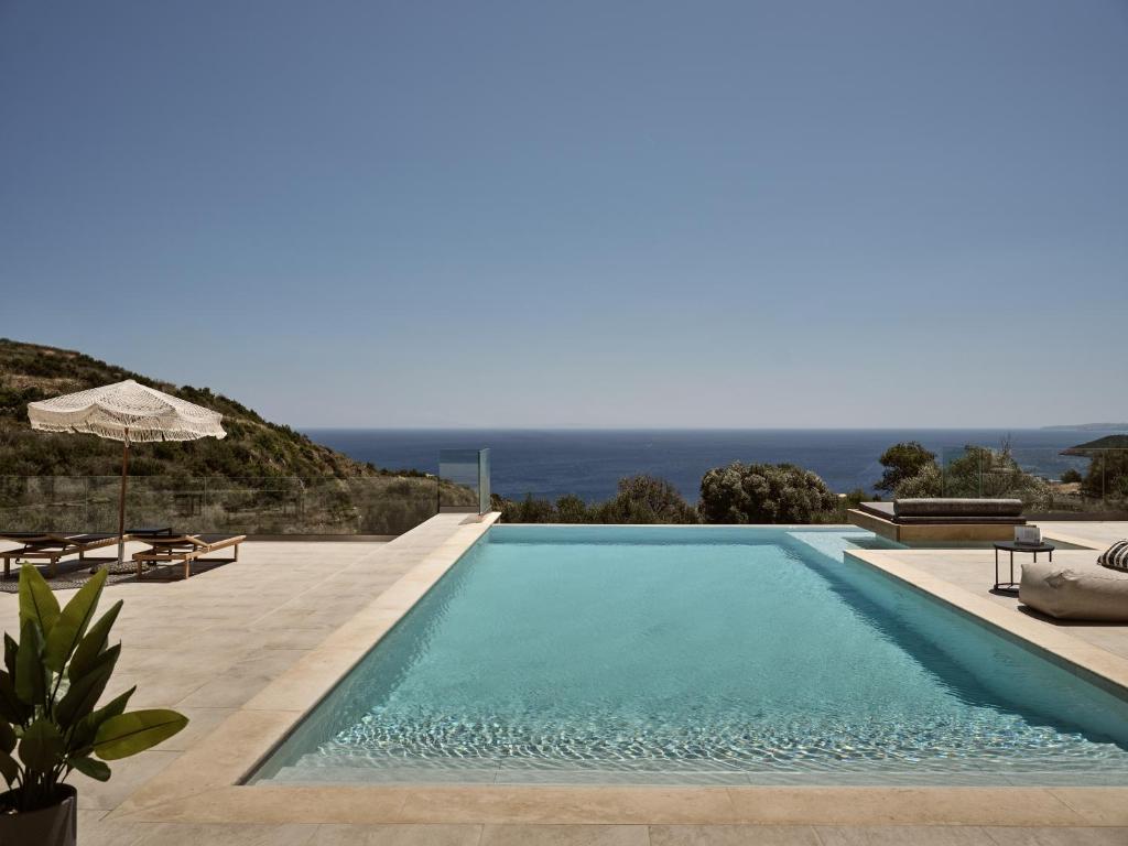 a swimming pool with a view of the ocean at Elle Lux Villa, Essence of Endless Blue, By ThinkVilla in Agios Nikolaos