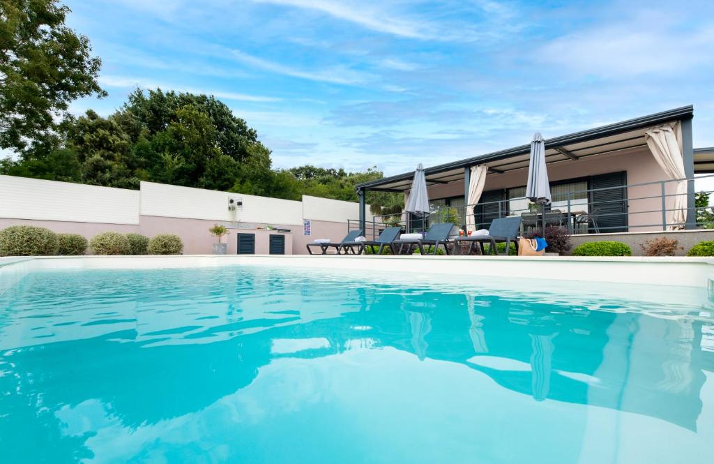 a swimming pool in front of a house at Vila Jolanda in Rovinj