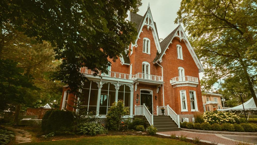 a large red brick building with a porch at Merrill House in Picton