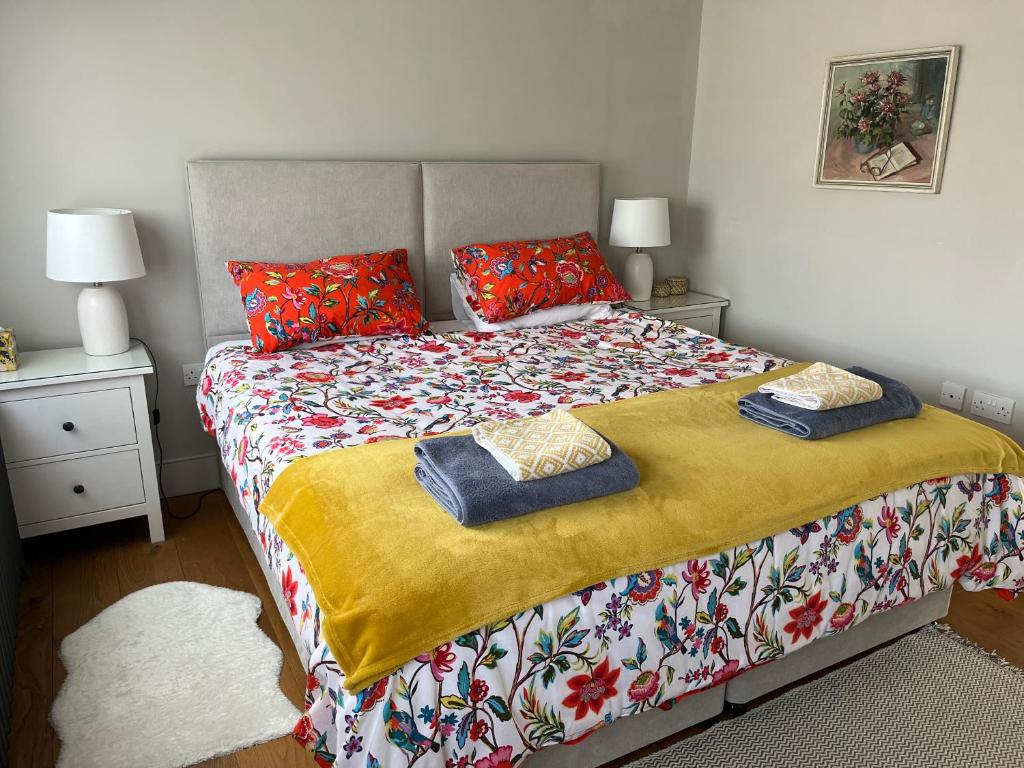 a bedroom with a large bed with pillows on it at Pretty Cottage in Central Lewes in Lewes