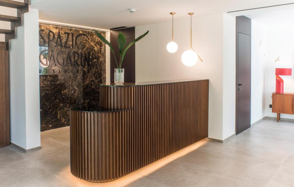 a lobby with a wooden partition with a potted plant at Spazio Gagarin Residence in Matera