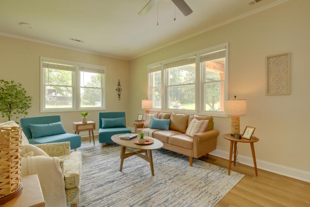 a living room with a couch and chairs and windows at Dog-Friendly Jackson Home Near Downtown Hub! in Jackson