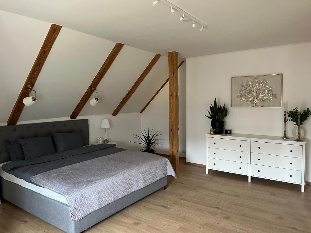 a bedroom with a bed and a white dresser at Kreutzwaldi Kodu 2 in Võru