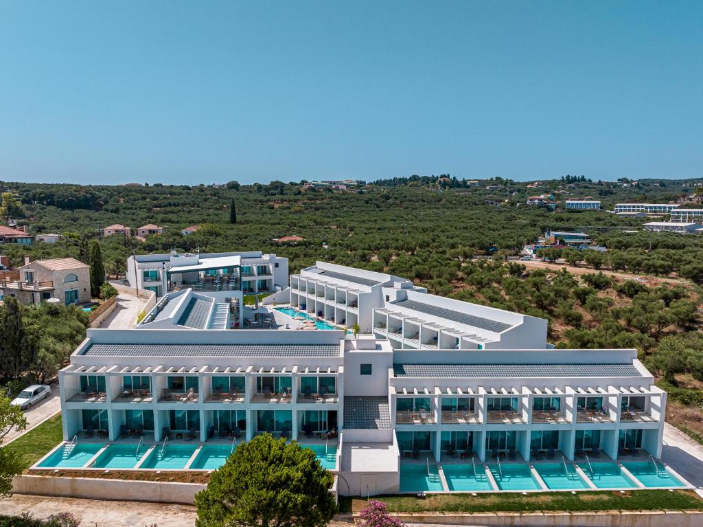 an aerial view of a building with a swimming pool at Mirage Bleu Hotel in Tragaki