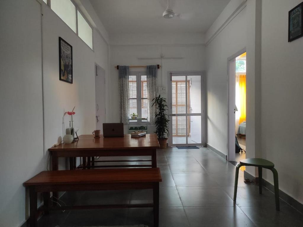 a room with a desk with a laptop on it at Golpo - Stories and Stays in Dibrugarh