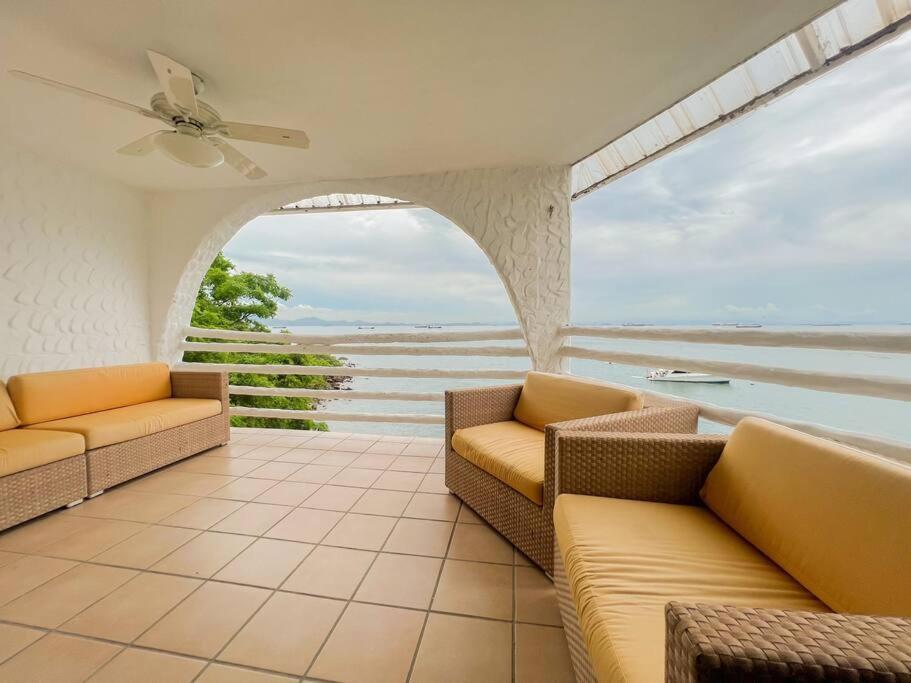 a living room with couches and a view of the ocean at Live an adventure in Taboga 1 in Taboga