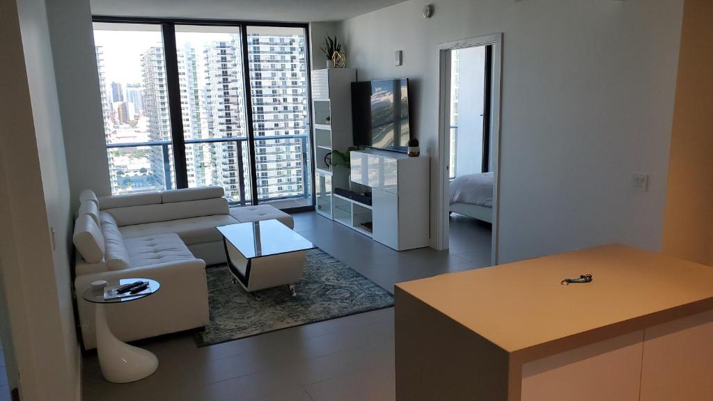 a living room with a couch and a tv at Canvas Condo in Miami