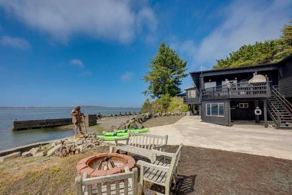 a house on the beach with a fire pit at Waterfront Coos Bay Retreat with Kayaks! in Coos Bay