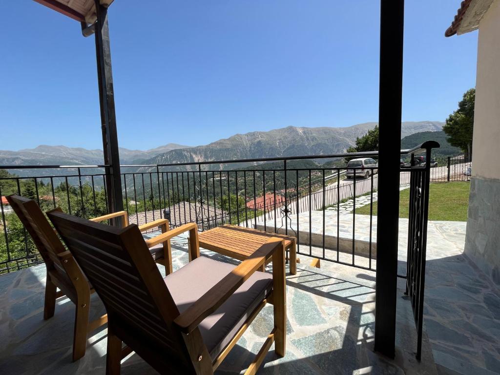 a balcony with a chair and a view of the mountains at Panorama House in Pramanta