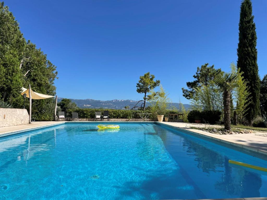 a large swimming pool with blue water at La Sauveterre in Mours-Saint-EusÃ¨be