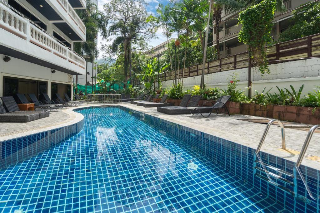 a swimming pool in the middle of a building at Patong Central Hotel and Apartment in Patong Beach