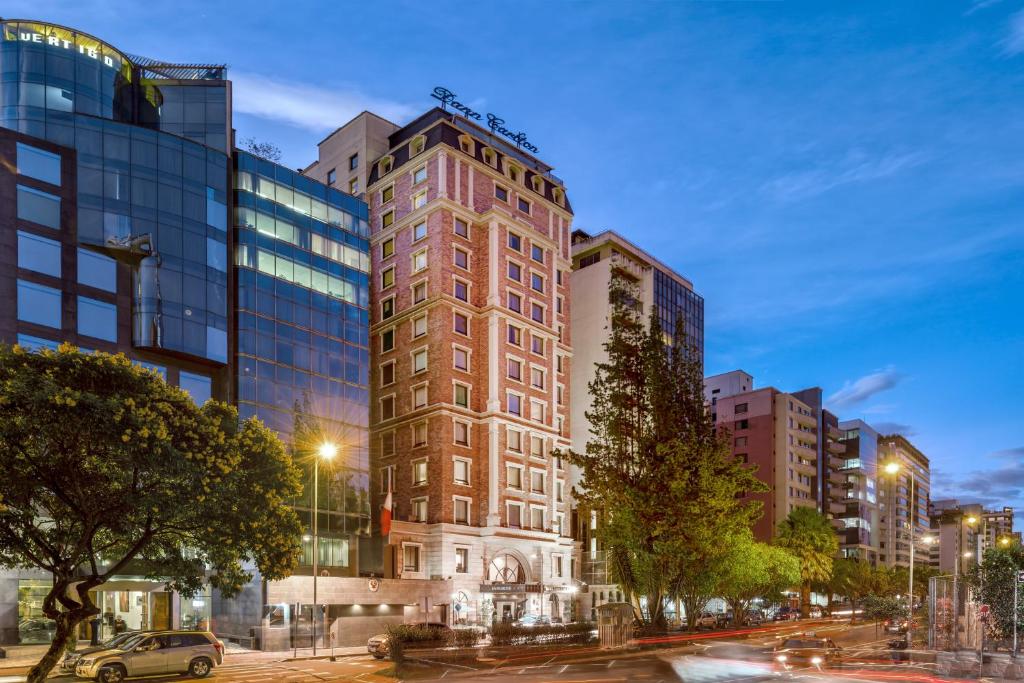 a tall building on a city street at night at Dann Carlton Quito in Quito