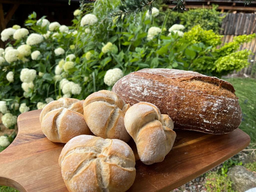 a bunch of loaves of bread on a cutting board at Penzion U Zemanů Nové Hrady in Nové Hrady