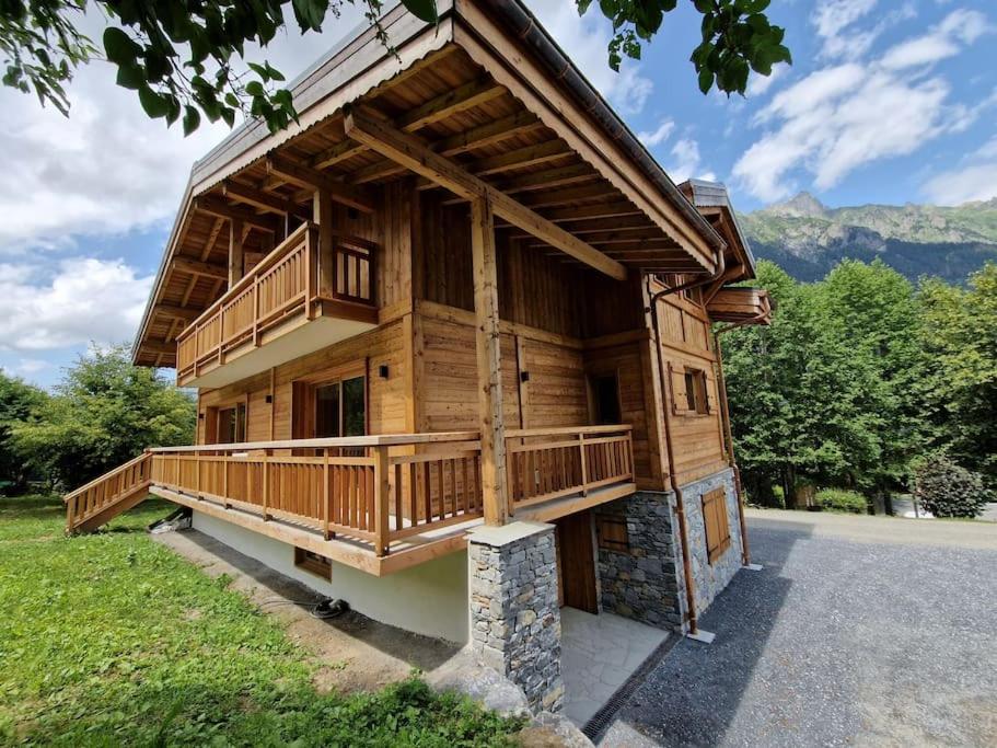 a large wooden house with a large deck at Chalet Manala in Chamonix-Mont-Blanc