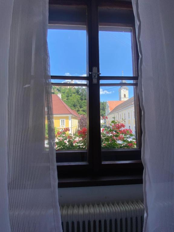 a window with a view of a house at Gasthof Seiser in Straßburg in Kärnten