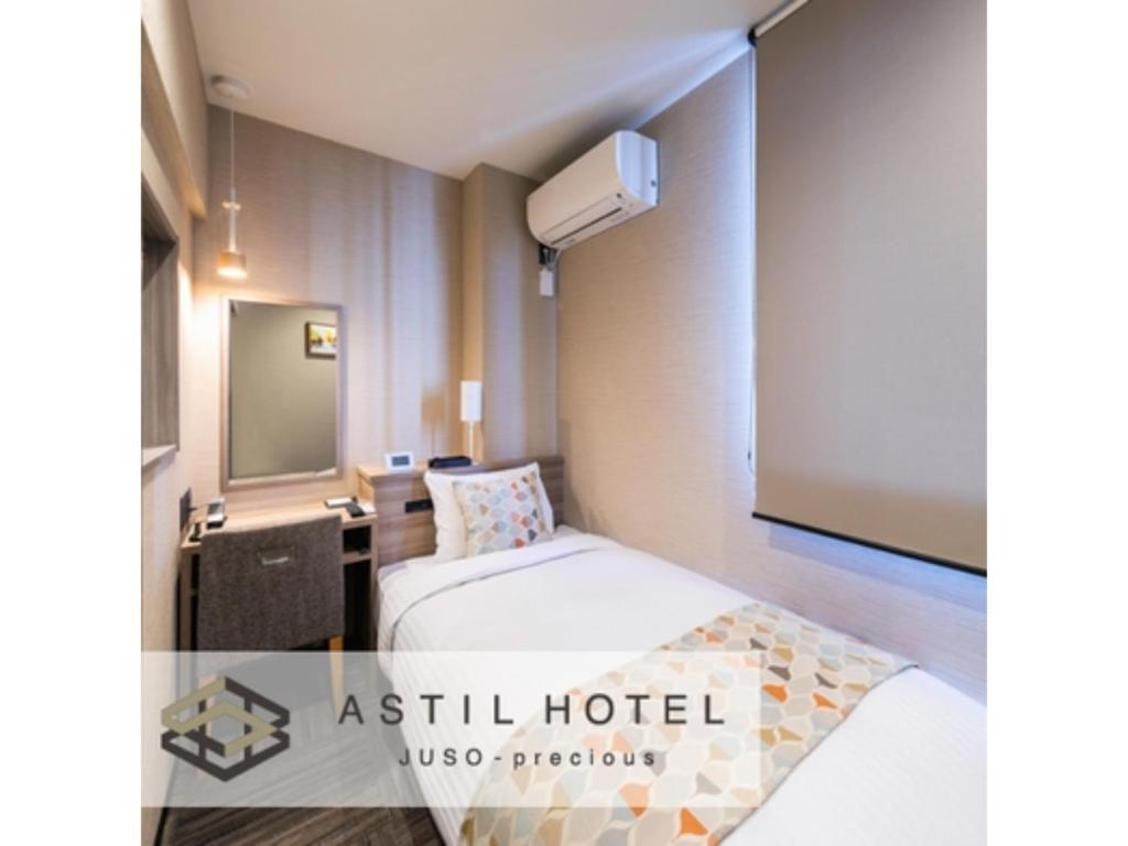 a hotel room with a bed and a projection screen at Astil Hotel Juso Precious - Vacation STAY 16022v in Osaka