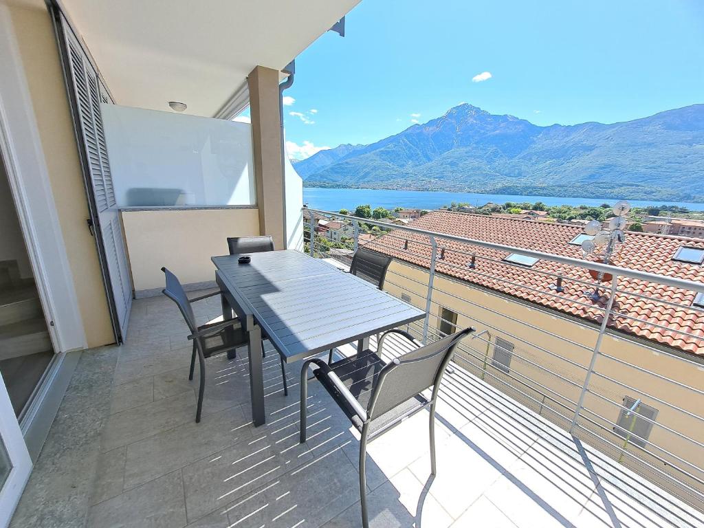 a table and chairs on a balcony with a view at Immobillario - Lakes Dream in Domaso