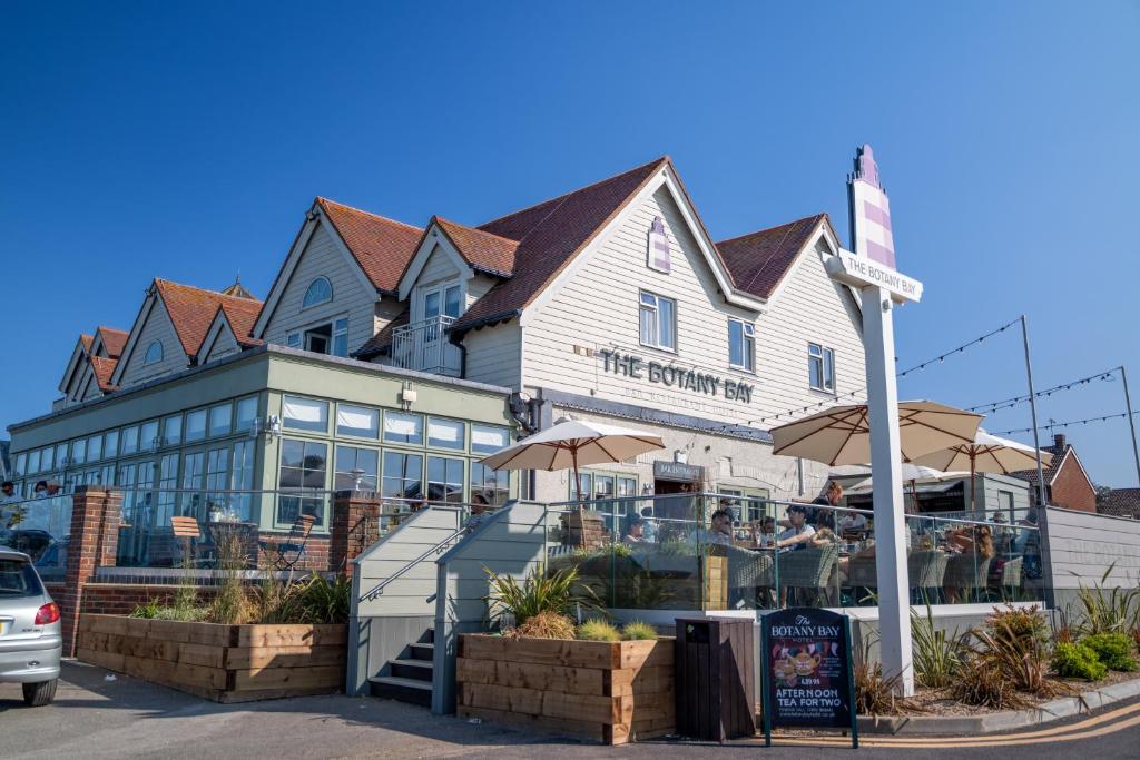 a restaurant with umbrellas in front of a building at Botany Bay Hotel in Broadstairs