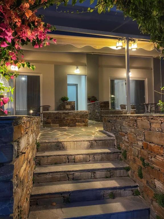 a set of stone steps leading up to a house at Giasemi apartments in Karistos