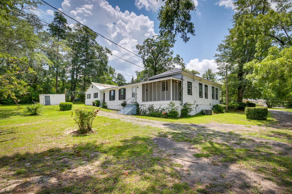 a white house in the middle of a yard at Historic Augusta Getaway with Screened Porch! in Augusta