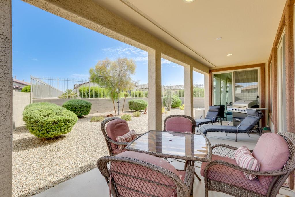 a patio with chairs and a glass table at Resort Amenities and Patio at 55 and Goodyear Escape! in Goodyear