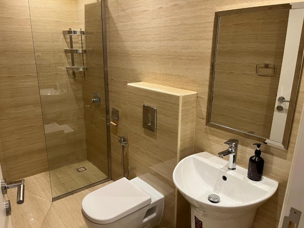 a bathroom with a toilet and a sink and a shower at الماجدية 53 ( A3) in Riyadh