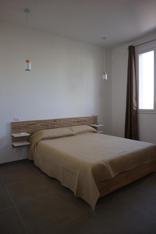 Postel nebo postele na pokoji v ubytování L'Atelier di Vittoria