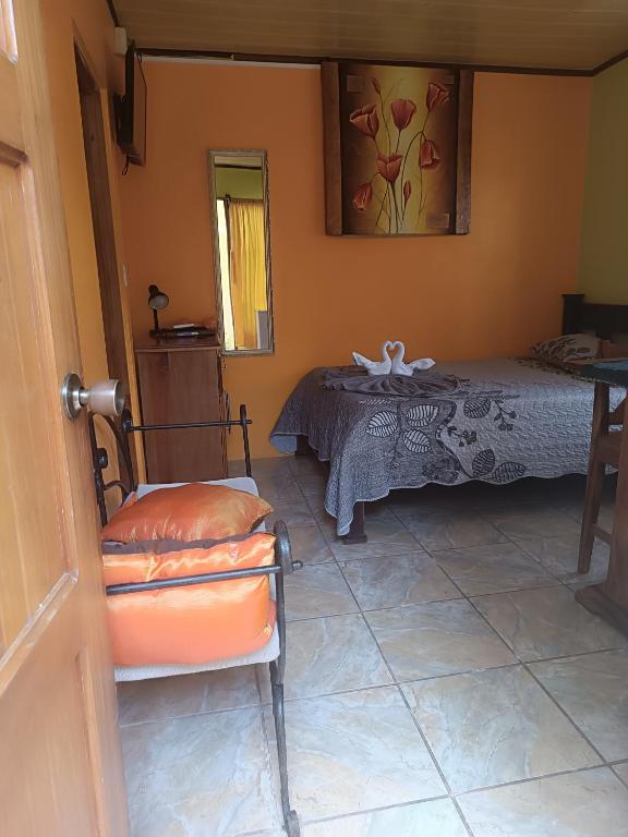 a room with a bed and a table and a chair at Apartamentos M&M in Fortuna